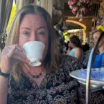 Photo of Christine Iliff drinking a tea
