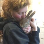Shoshana holding a pet rabbit.