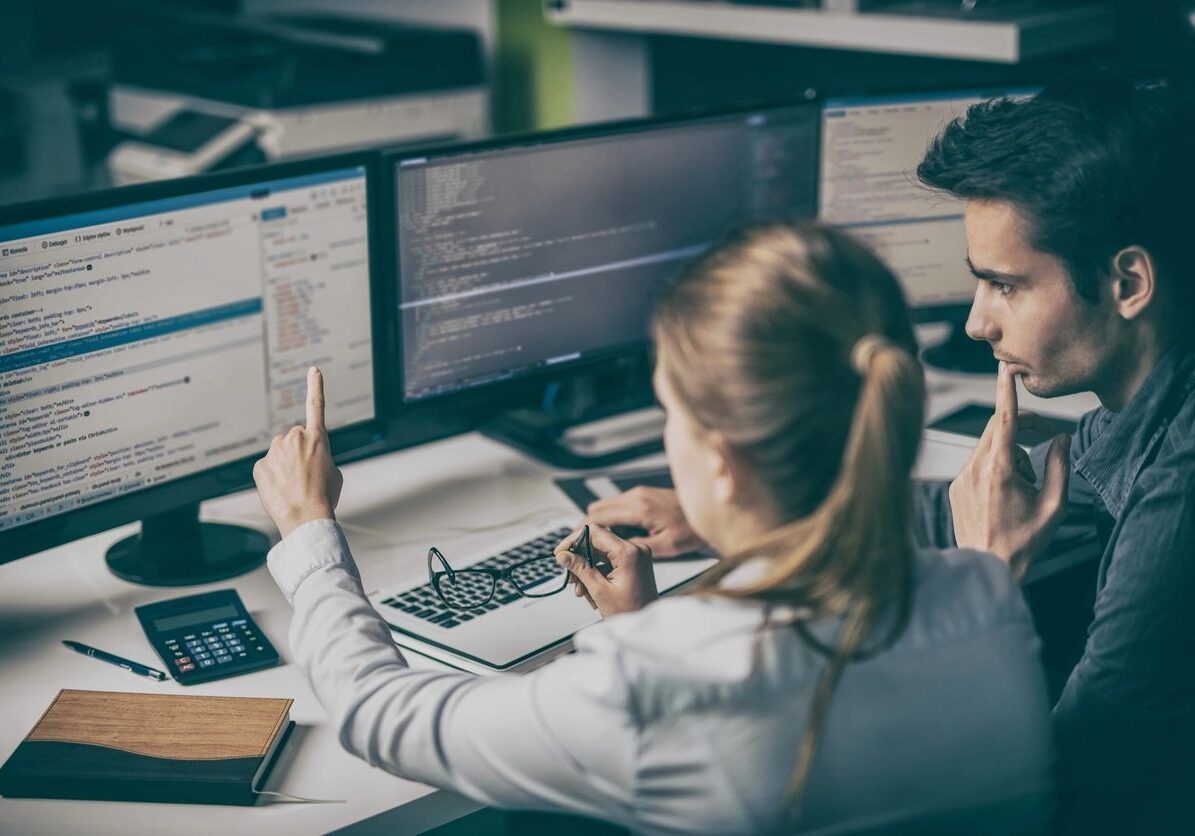 Two people looking at computer screen together