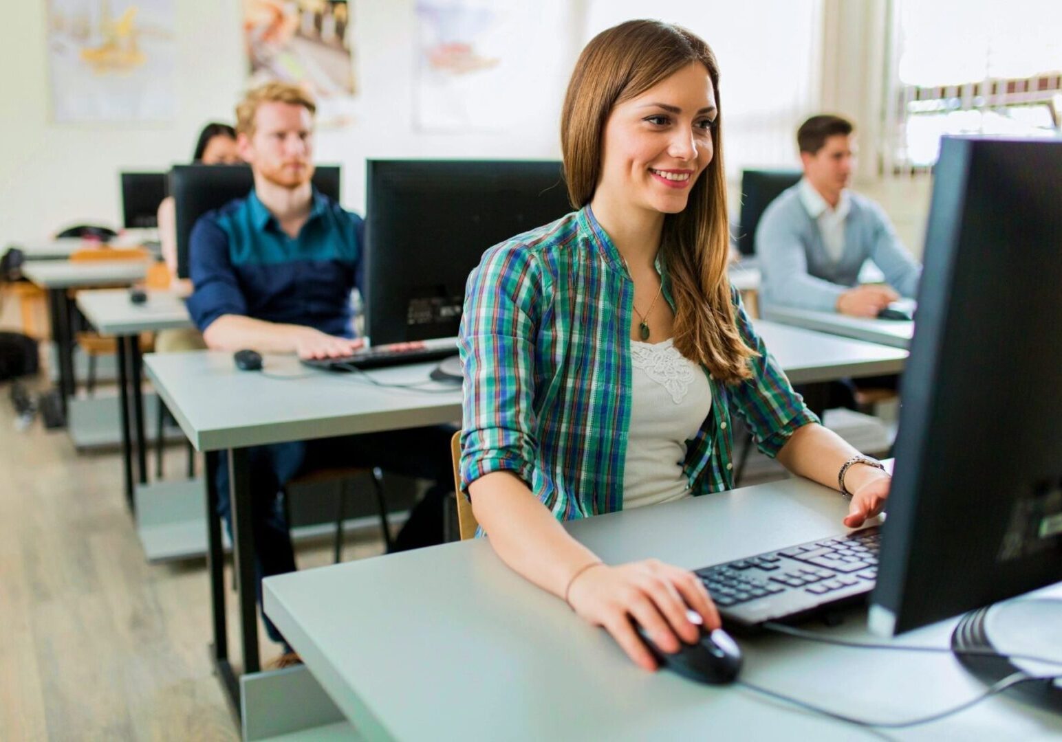 People using computers in a classroom